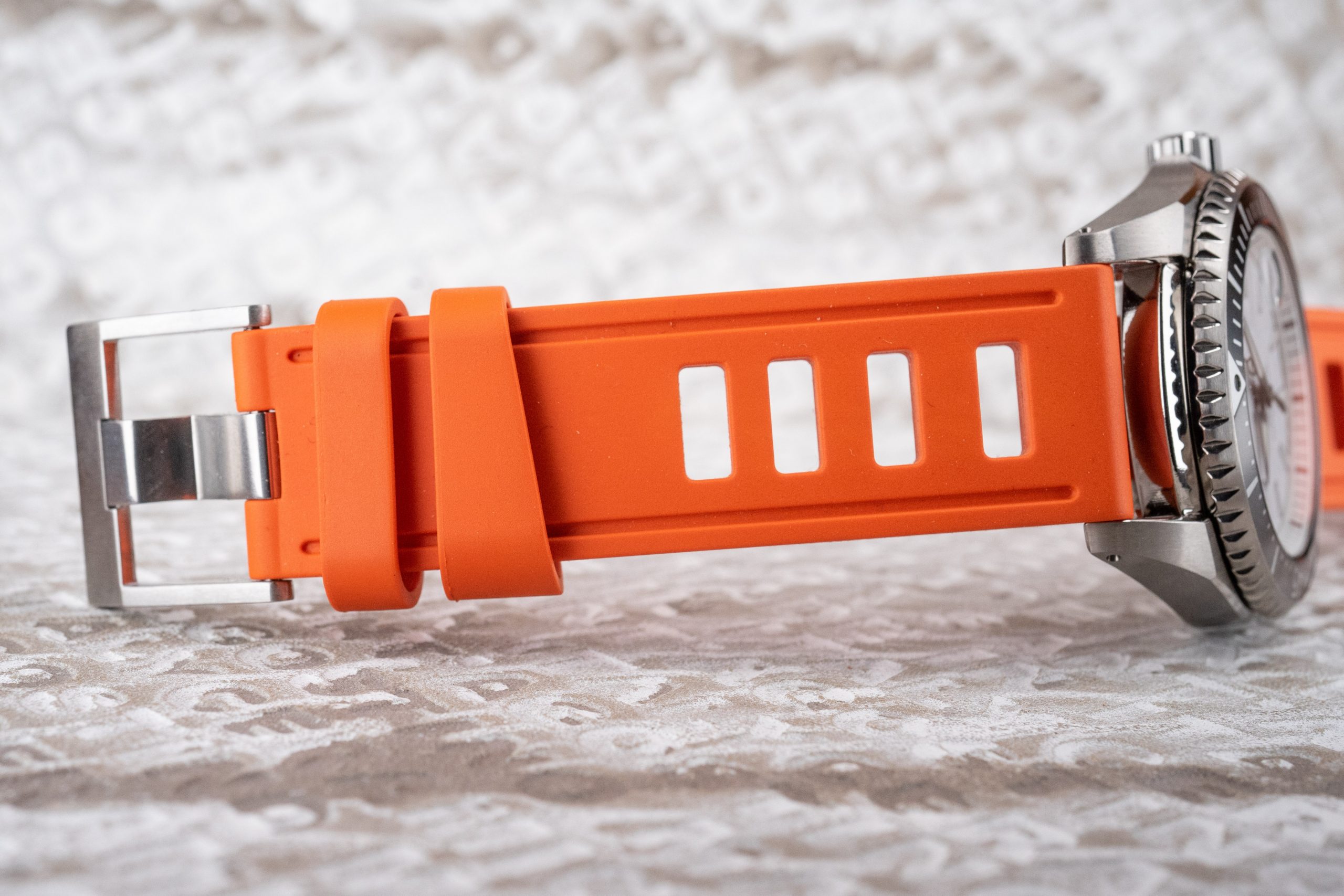 An orange Isofrane Vulcanized Rubber Strap on a Seiko titanium Shogun dive watch.