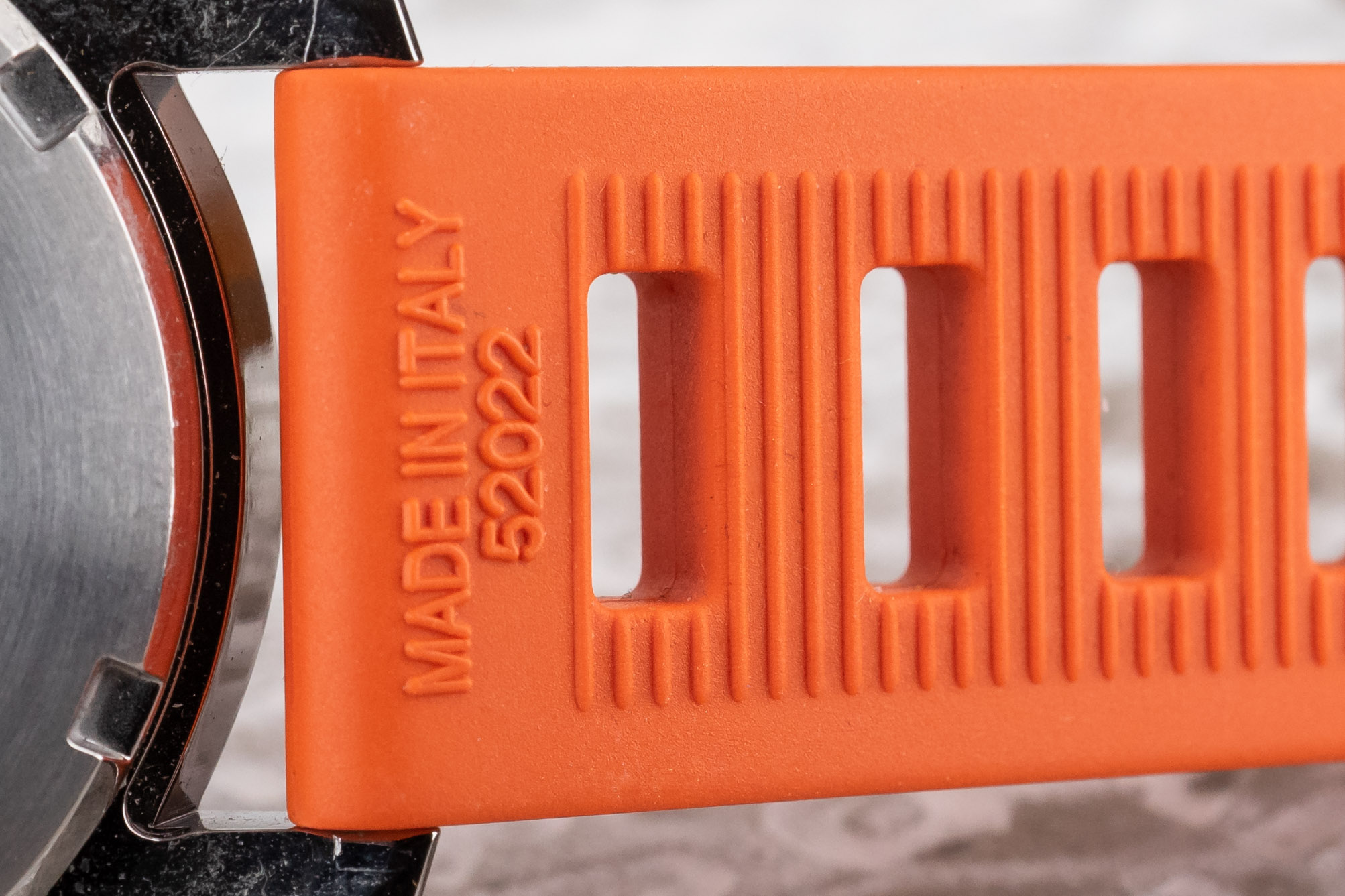 An orange Isofrane Vulcanized Rubber Strap on a Seiko titanium Shogun dive watch.