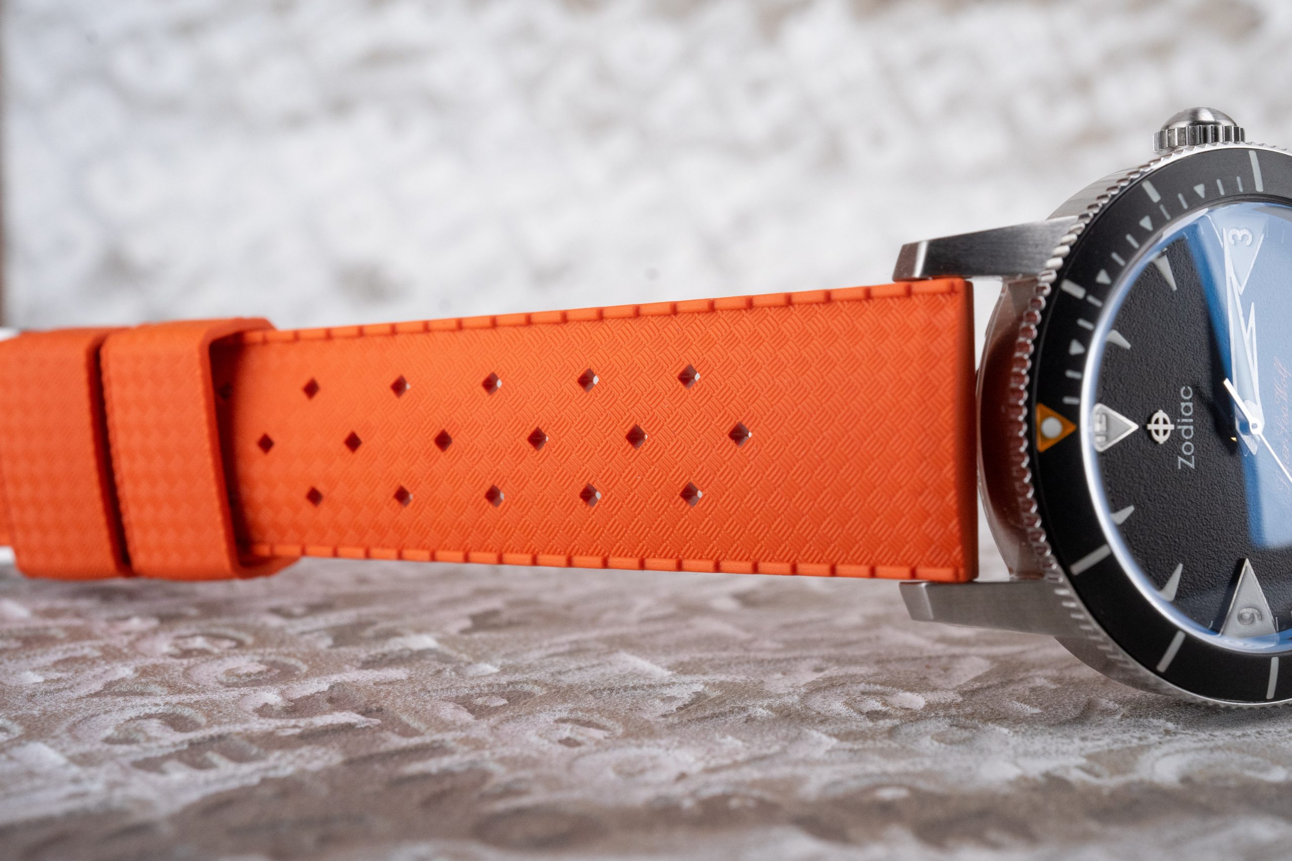 An orange Tropic Vulcanized Rubber Strap on a Zodiac dive watch.